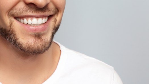 Close up of smiling man with short facial hair