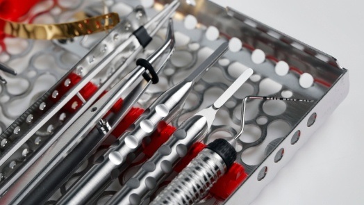 Several dental instruments in metal case