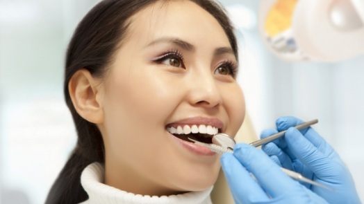 Smiling woman receiving dental checkup