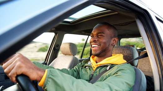 Man smiles while driving