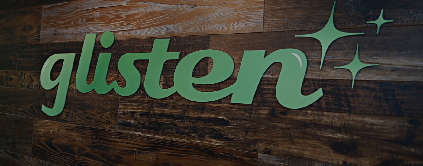 Sign on wall saying Glisten