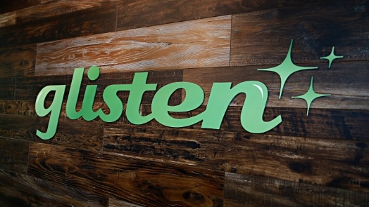 Sign on wall saying Glisten