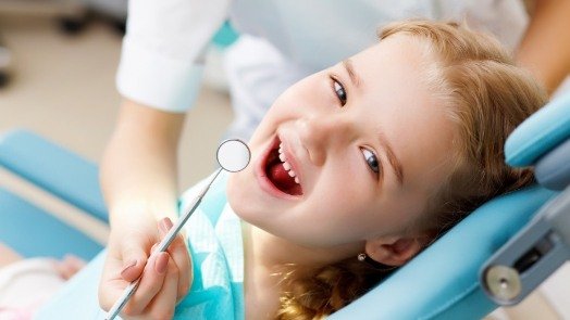 Smiling child receiving a dental checkup