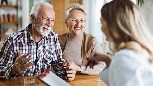 Senior couple talking to a receptionist