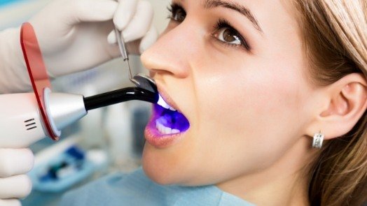 Woman receiving dental bonding from Tulsa cosmetic dentist
