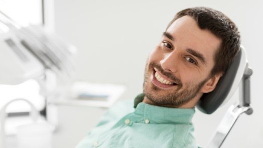 Smiling man leaning back in dental chair