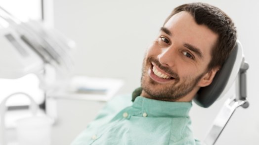 Smiling man leaning back in dental chair