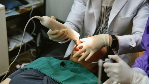 Dentist capturing digital dental impressions of teeth