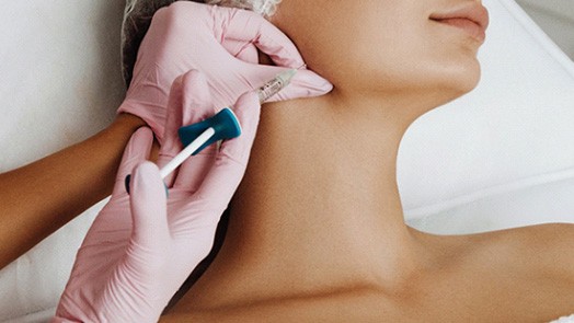 Woman having filler injected into the jaw