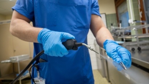 Dental team member steaming a dental instrument