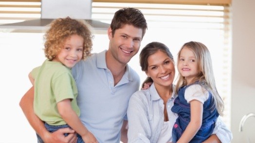 Mother father and two children visiting family dentist in Tulsa