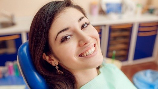 Young woman smiling in dental chair