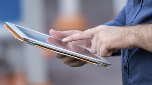 Dental team member typing on tablet