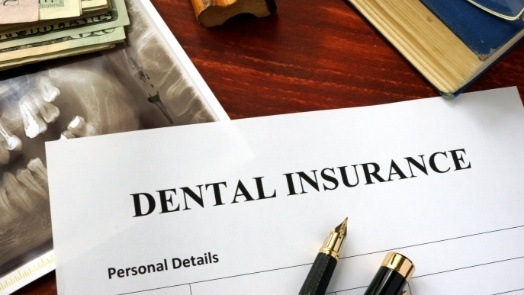 Dental insurance form on wood table