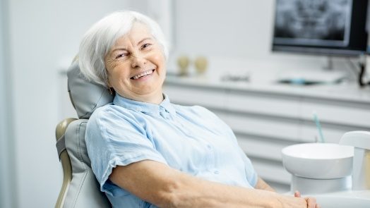 Senior woman smiling in dental chair