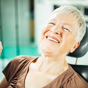 An older woman experiencing the benefits of dental implants