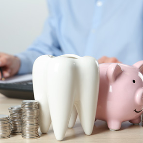 Coins next to a piggy bank