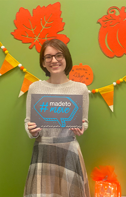 Tulsa dental patient holding small chalkboard that says hashtag made to move