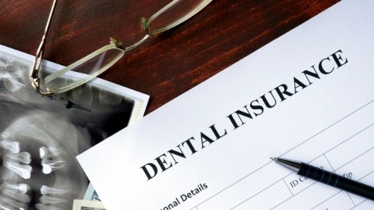 Dental insurance form on dark wood table