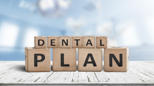 Wooden block letters spelling out the words dental plan