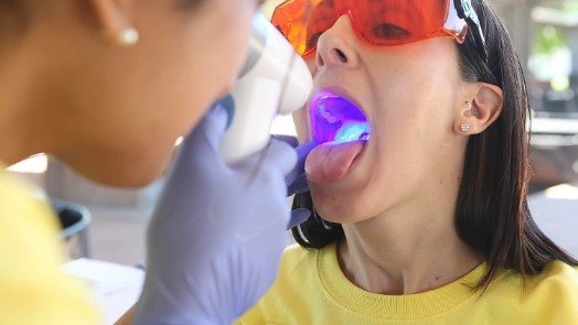 Dentist giving a patient an oral cancer screening in Tulsa