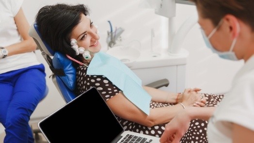 Woman receiving T M J treatment from her dentist