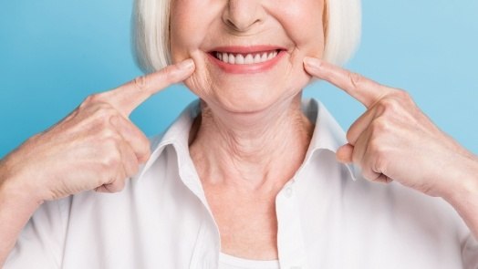 Close up of senior woman pointing to her smile