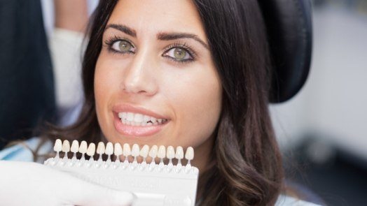 Woman trying on dental veneers from Tulsa cosmetic dentist