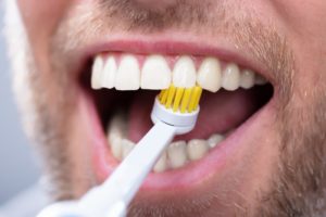 person brushing their teeth