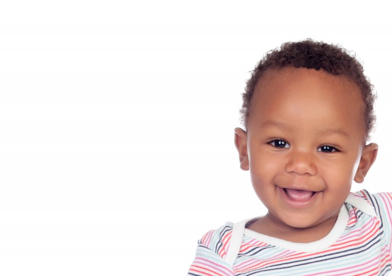 a happy baby wearing a striped onesie