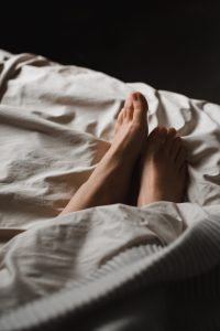 Woman’s feet in bed at a sleep test in Tulsa