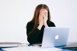 Woman sitting at computer experiencing anxiety
