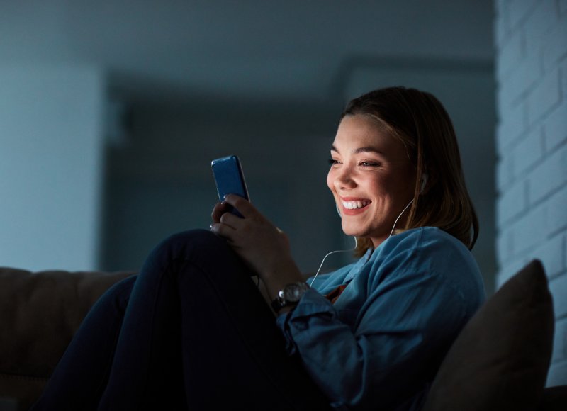 woman using cell phone at night