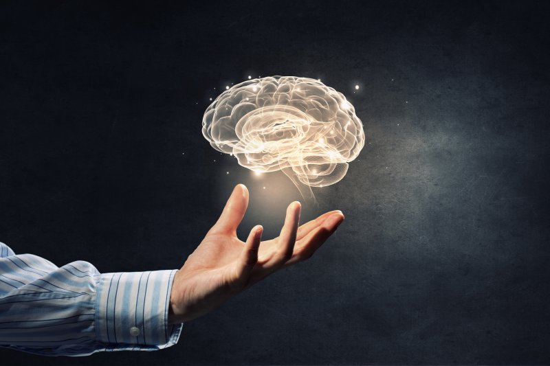 person holding floating brain