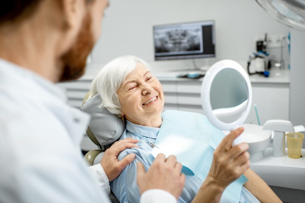 Older woman at her dental implant consultation.