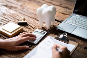 A patient filling out their dental insurance paperwork.