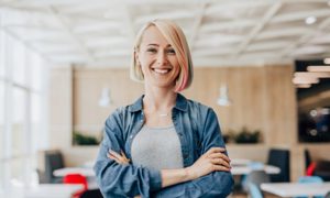 Woman smiling at her office job.