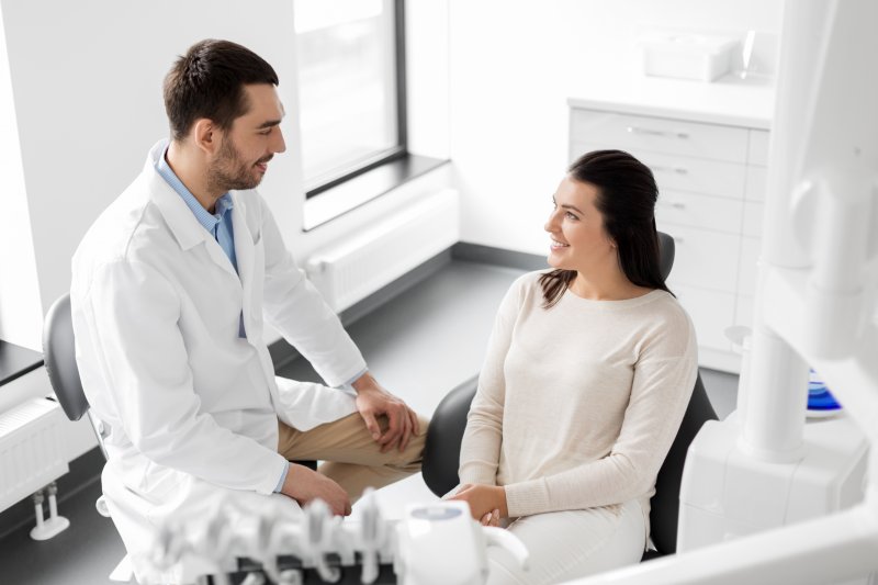 dentist talking to patient about cost of dental implants