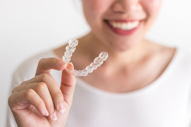smiling patient with Invisalign during the holidays 