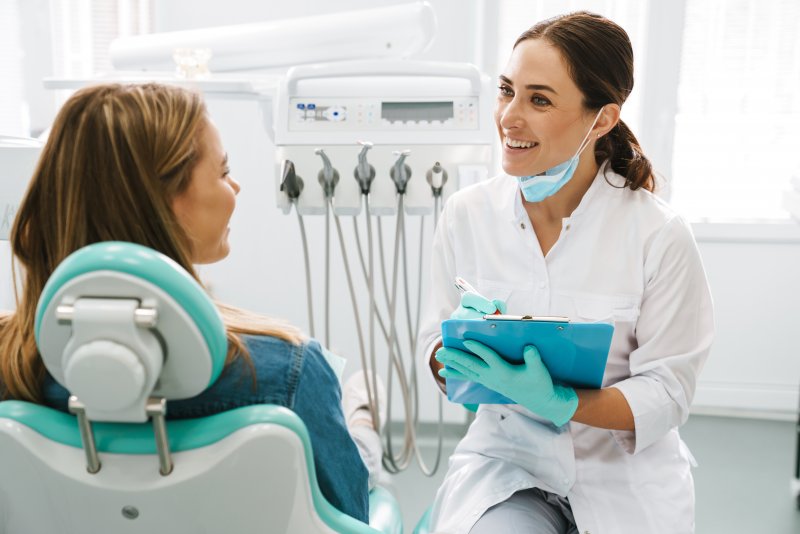 A dentist talking with a patient during a cosmetic dental consultation