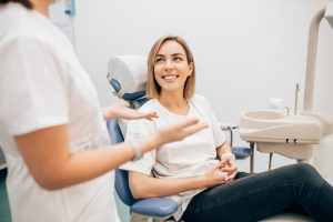 a patient talking to a dentist about her oral health