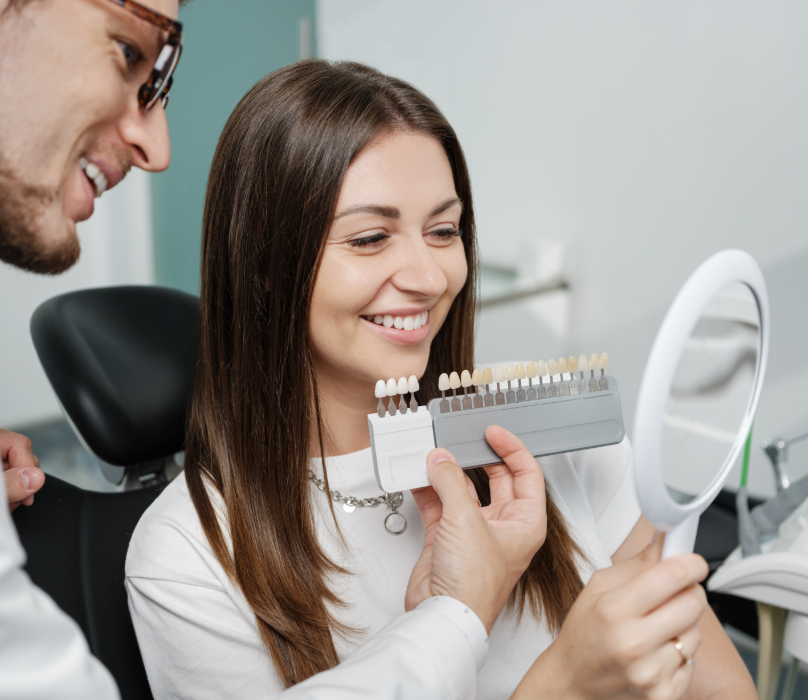 Dentist showing patient veneer options